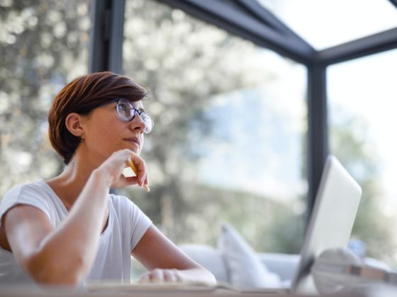 woman working on her laptop and thinking