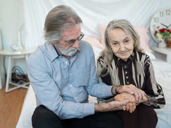 senior-husband-and-wife-holding-hands-to-encourage