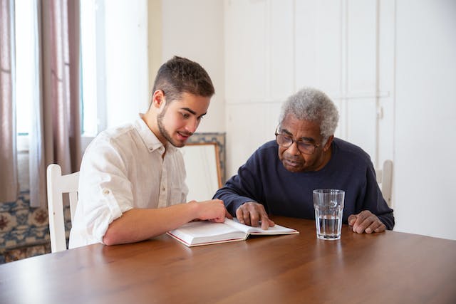 two-men-looking-at-a-book-together-for-speech-therapy-memory-activities-for-adults