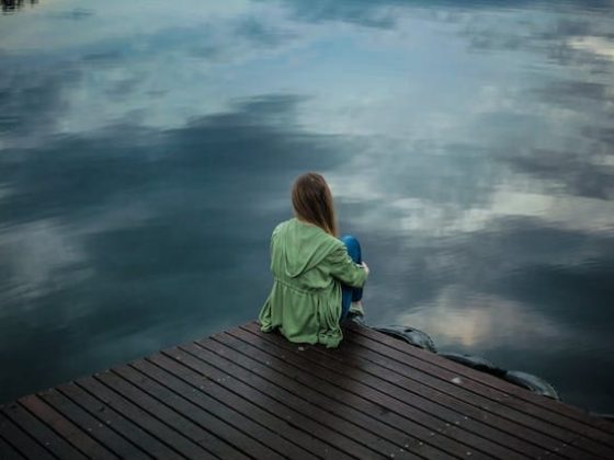 woman-sitting-alone-by-a-lake-for-green-light-therapy-for-depression